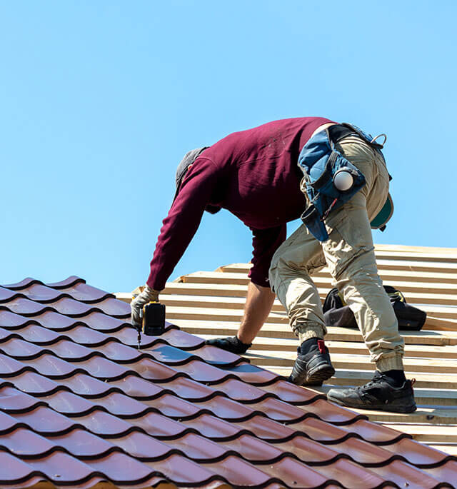 roofer installing residential metal roofing